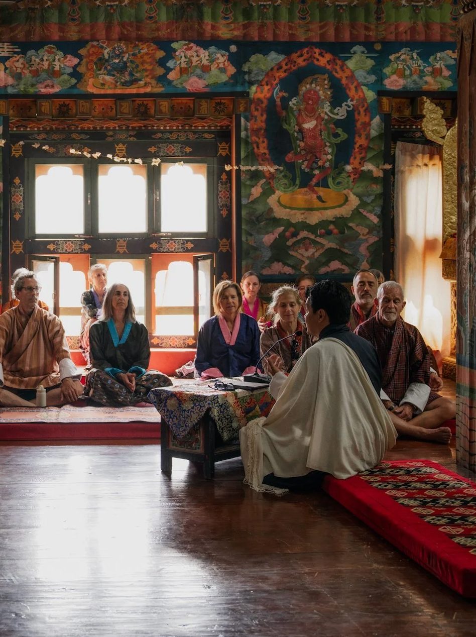 Travellers listening to a teaching inside a Bhutanese temple